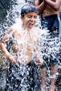 Kids enjoying and having fun with Ravana waterfall, Sri Lanka